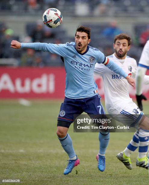 March 18: David Villa of New York City FC is challenged by Hernan Bernardello of Montreal Impact during the New York City FC Vs Montreal Impact...