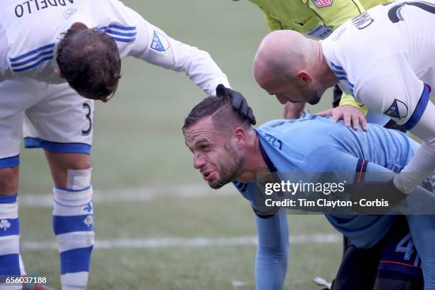 March 18: Maxime Chanot of New York City FC is consoled by Laurent Ciman of Montreal Impact and Hernan Bernardello of Montreal Impact during the New...