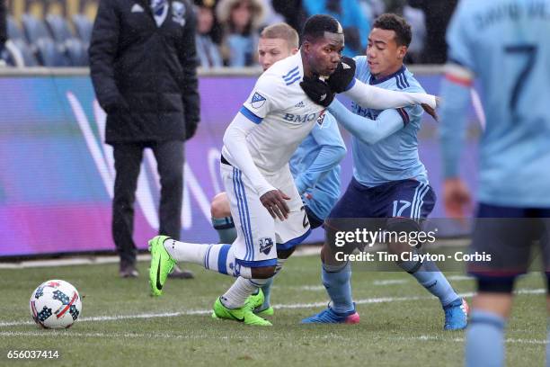 March 18: Ambroise Oyongo of Montreal Impact is challenged by Jonathan Lewis of New York City FC during the New York City FC Vs Montreal Impact...