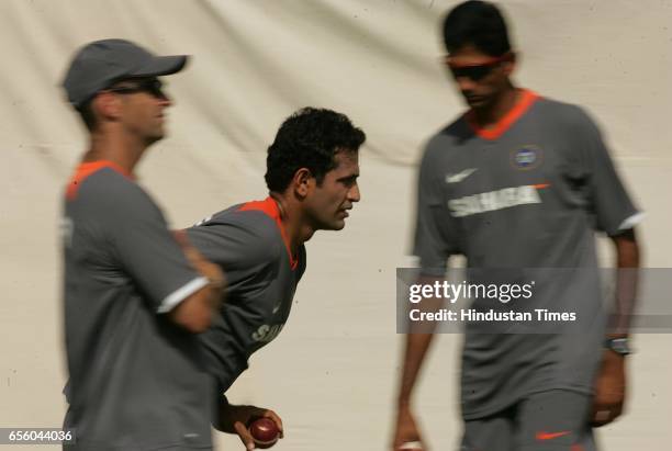 Indian cricketer Irfan Pathan bowls as coach Gary Kirsten and bowling coach Venkatesh Prasad watches during Indian cricketer net practice session...