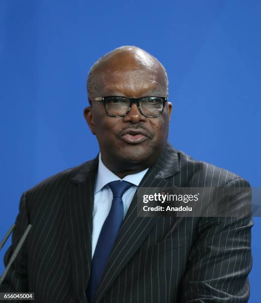 President of Burkina Faso, Roch Marc Christian Kabore delivers a speech during a joint press conference with German Chancellor Angela Merkel after...