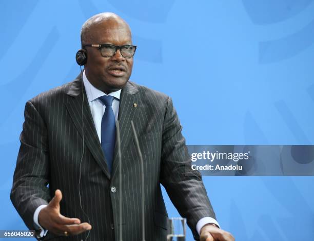 President of Burkina Faso, Roch Marc Christian Kabore delivers a speech during a joint press conference with German Chancellor Angela Merkel after...