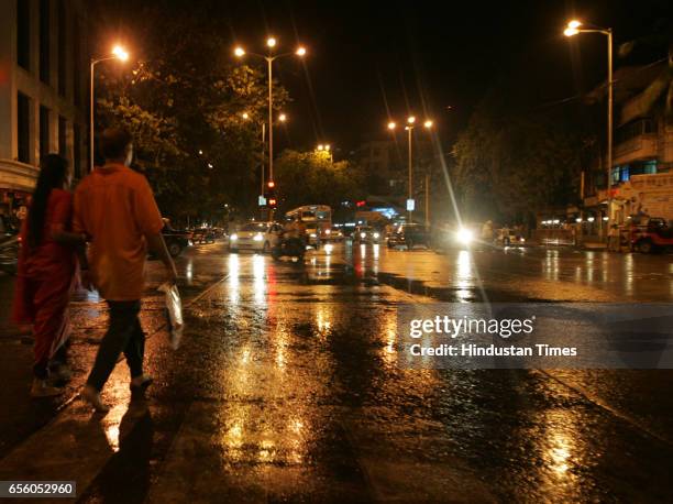 Pre-monsoon rain showers - Mumbai by Night - Street Lights - People enjoys being getting wet in the first shower city experienced.