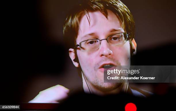 Whistleblower Edward Snowden is broadcast live from Russia at the Sakura Stage at the CeBIT 2017 Technology Trade Fair on March 21, 2017 in Hanover,...