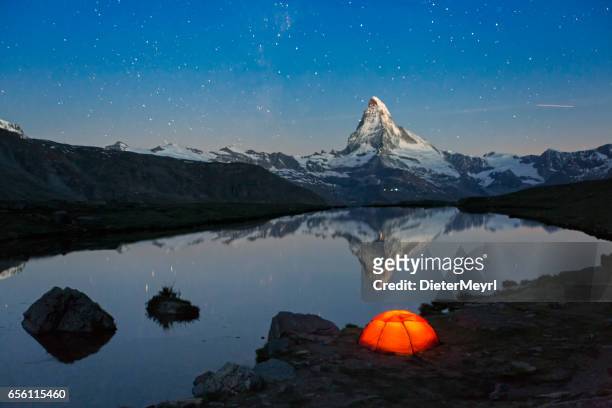 loneley tent under stary sky at matterhorn - european alps stock pictures, royalty-free photos & images