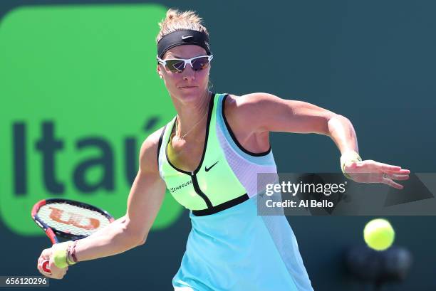 Mandy Minella of Luxenburg plays a backhand against Kristyna Pliskova of the Czech Republic during Day 2 of the Miami Open at Crandon Park Tennis...