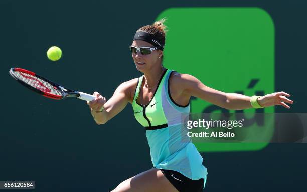 Mandy Minella of Luxenburg plays a backhand against Kristyna Pliskova of the Czech Republic during Day 2 of the Miami Open at Crandon Park Tennis...