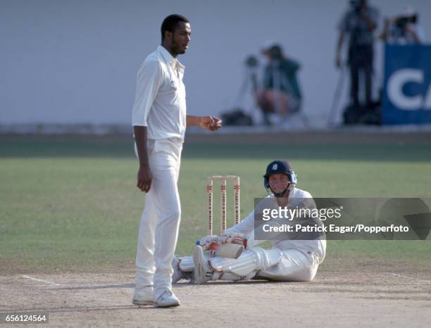 England captain Mike Atherton looks up at West Indies bowler Courtney Walsh after being floored by a bouncer during the 1st Test match between West...
