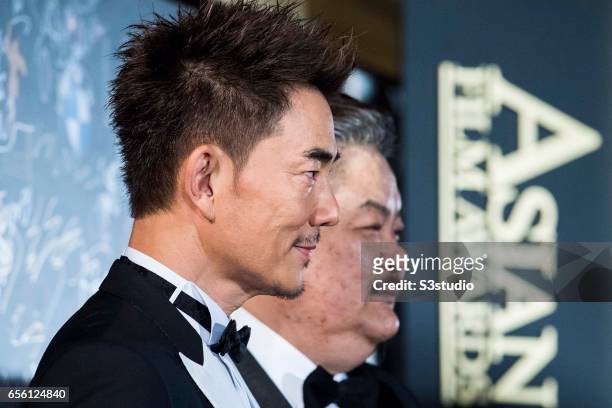 Actor and singer Richie Jen of Taiwan and actor Lam Suet of Hong Kong pose on the red carpet during the 11th Asian Film Awards on March 21, 2017 at...