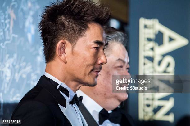 Actor and singer Richie Jen of Taiwan and actor Lam Suet of Hong Kong pose on the red carpet during the 11th Asian Film Awards on March 21, 2017 at...