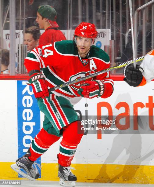 Adam Henrique of the New Jersey Devils in action against the Philadelphia Flyers on March 16, 2017 at Prudential Center in Newark, New Jersey. The...