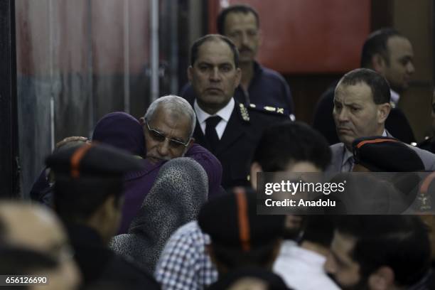 General Guide of the Egyptian Muslim Brotherhood Mohammed Badie hugs with his sister as he arrives at Cairo Police Academy during the trial session...