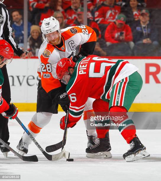 Blake Pietila of the New Jersey Devils in action against Claude Giroux of the Philadelphia Flyers on March 16, 2017 at Prudential Center in Newark,...