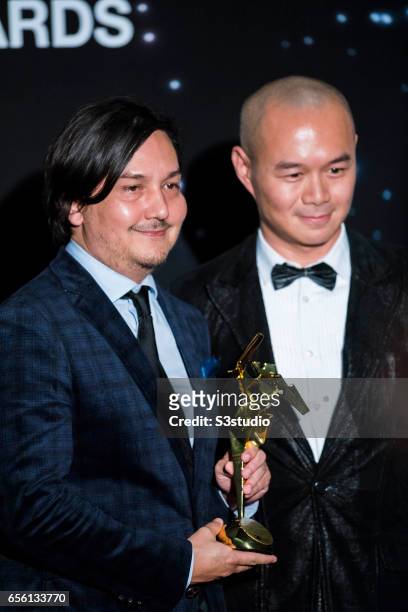 Lee Chatametikool , one of the winners of the Best Editing award for 'Apprentice', poses with the film producer Raymond Phathanavirangoon during the...