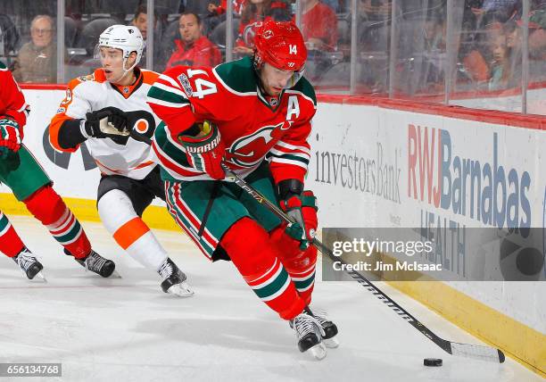 Adam Henrique of the New Jersey Devils in action against the Philadelphia Flyers on March 16, 2017 at Prudential Center in Newark, New Jersey. The...