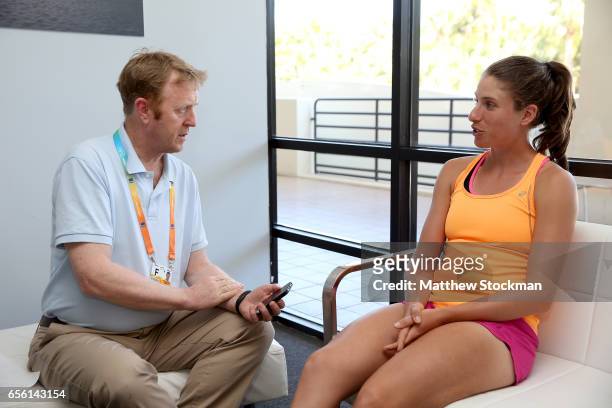 Johanna Konta of Great Britain fields questions from Mike Dickson of the Daily Mail at a player availability session during the Miami Open at the...