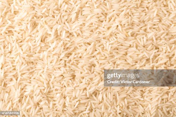 long grain basmati rice background - basmati rice stock-fotos und bilder