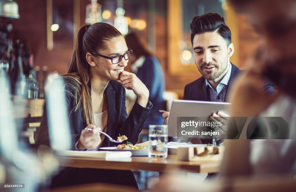 Uomini d'affari al ristorante Cafe che discutono durante il pranzo di lavoro