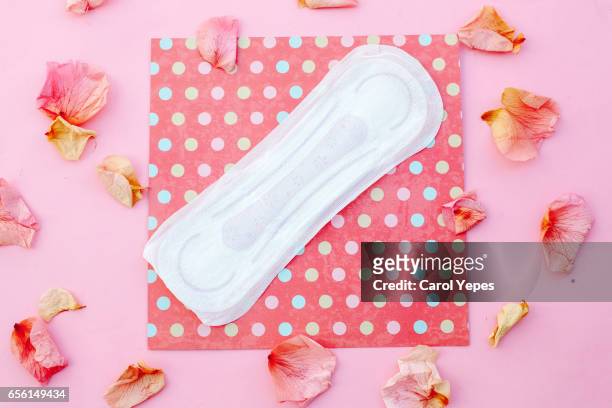 sanitary pad with rose petals.pink background - sports period stock pictures, royalty-free photos & images