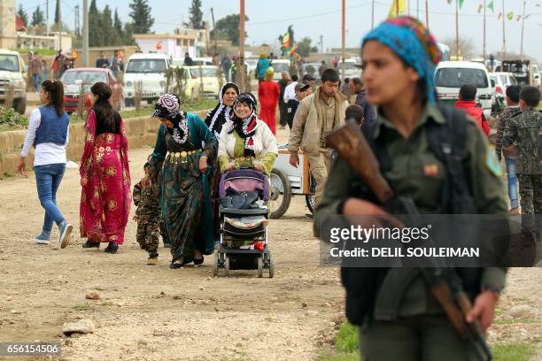 Syrian Kurds take part in the annual celebrations of Noruz, the Persian New Year, on March 21 in the northeastern Syrian city of Qamishli. - The...
