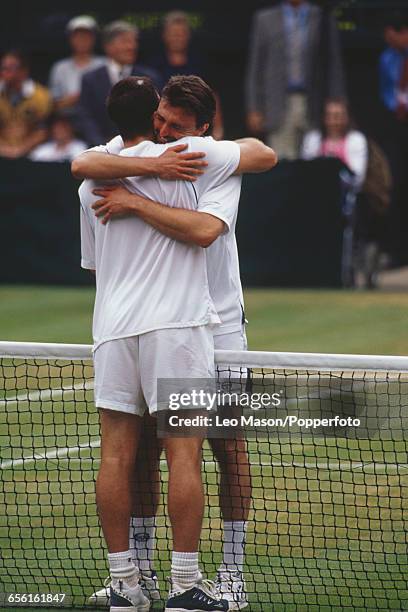 Croatian tennis player Goran Ivanisevic hugs Australian tennis player Pat Rafter after defeating him in the final of the Men's Singles tournament,...