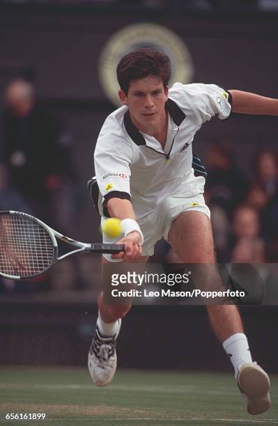 English tennis player Tim Henman pictured in action during competition to reach the semifinals of the Men's Singles tournament at the Wimbledon Lawn...
