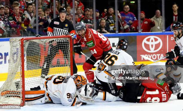 Jean Francois Boucher of Koeln fails to score over Felix Brueckmann, goaltender of Wolfsburg during the DEL Playoffs quarter finals Game 7 between...