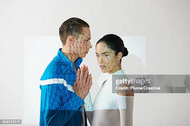 Portrait of two people with hands together