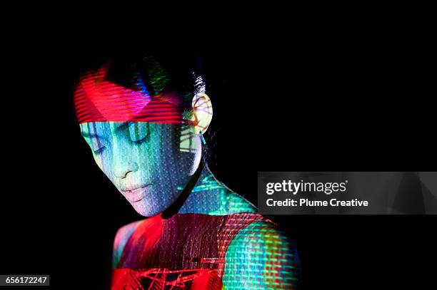 woman with abstract shapes across her face - conceptual bold red stock-fotos und bilder