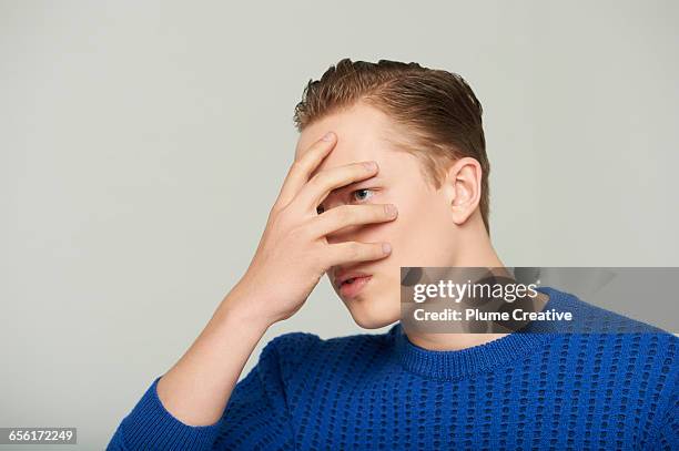 young man with hands on his face - hand covering face stock pictures, royalty-free photos & images