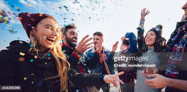 hipster friends throwing confetti and celebrating together - 2017 celebration stock pictures, royalty-free photos & images