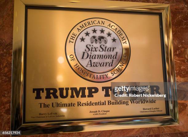 Plaque is displayed on a wall inside the lobby as tourists and curiosity seekers visit Trump Tower March 20, 2017 along Fifth Avenue in New York...