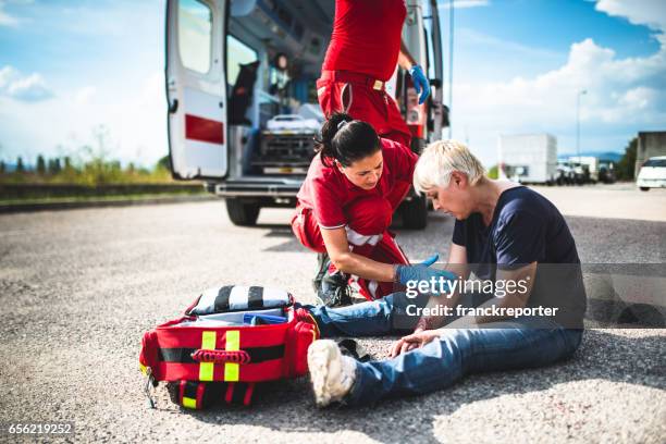 injured woman at the edge of the road - victim advocacy stock pictures, royalty-free photos & images