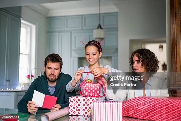 happy family preparing gift boxes for christmas - gift wrap stock-fotos und bilder