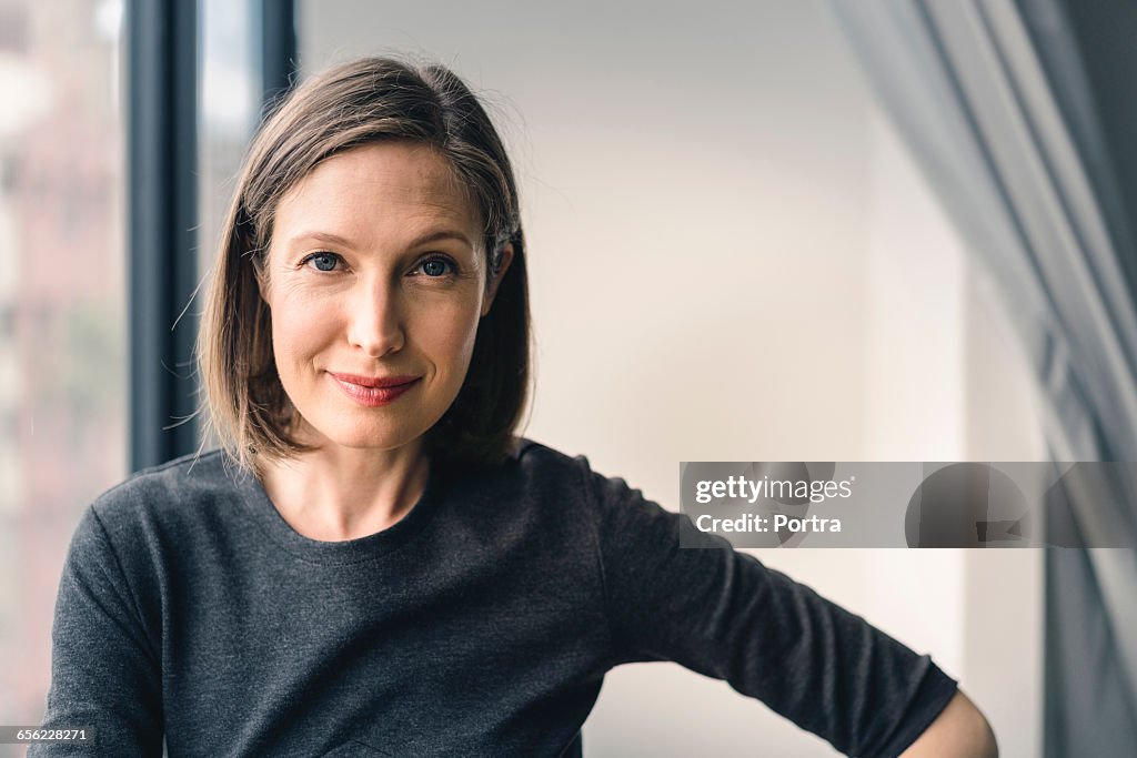 Confident businesswoman smiling in office