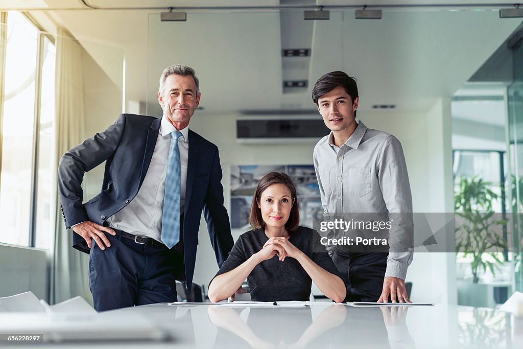 Portrait of confident business people at desk