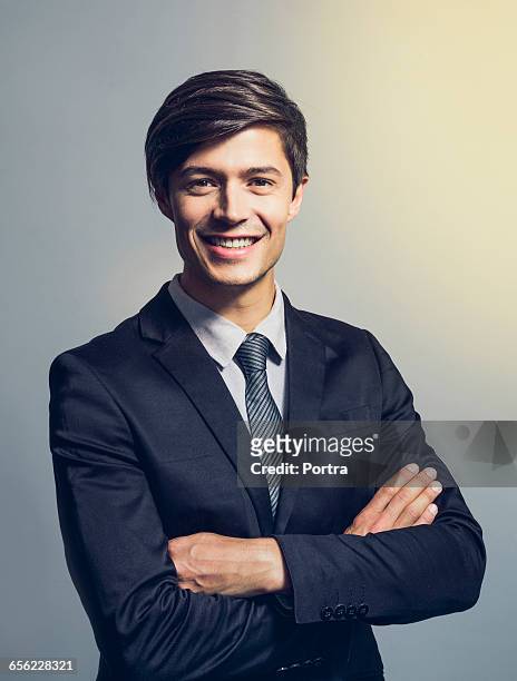 confident businessman with arms crosse - suit and tie stock pictures, royalty-free photos & images