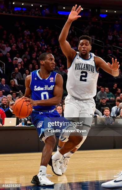 Khadeen Carrington of the Seton Hall Pirates is defended by Kris Jenkins of the Villanova Wildcats during the Big East Basketball Tournament -...