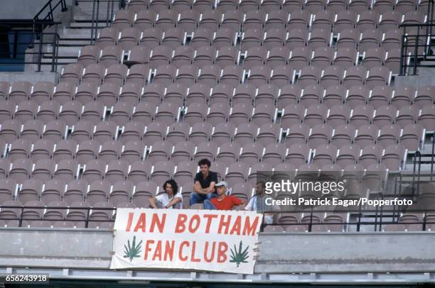 Some fans display a banner in tribute to England cricketer Ian Botham during the World Cup group match between England and West Indies at the MCG,...