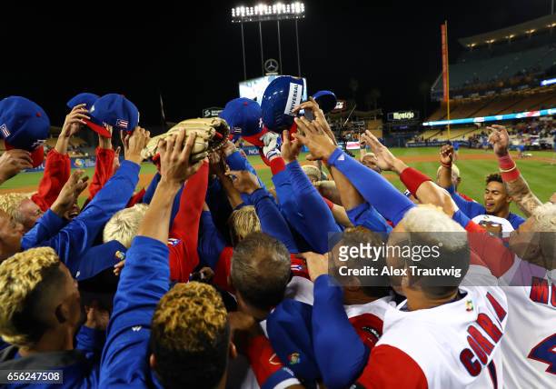 Team Puerto Rico raises their caps in a huddle after Game 1 of the Championship Round of the 2017 World Baseball Classic against Team Netherlands on...