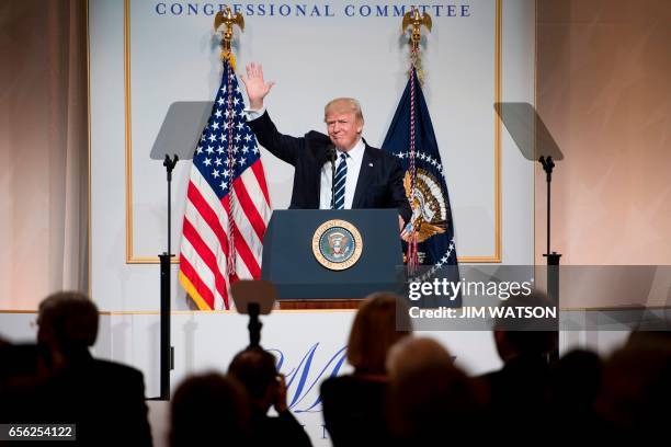 President Donald Trump waves to the crowd as he arrives to address the annual National Republican Congressional Committee dinner in Washington, DC,...