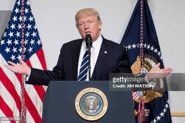 President Donald Trump addresses the annual National Republican Congressional Committee dinner in Washington, DC, March 21, 2017. / AFP PHOTO / JIM...