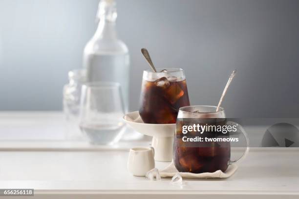 two cup of iced black coffee. - iced coffee stock pictures, royalty-free photos & images