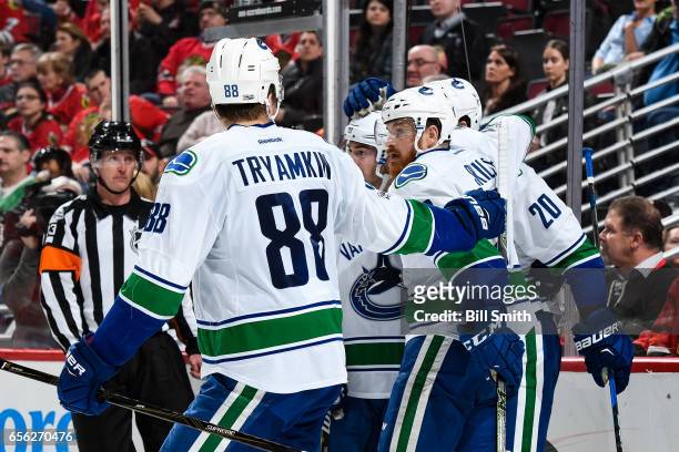 Jack Skille of the Vancouver Canucks celebrates with teammates after the Canucks scored in the second period against the Chicago Blackhawks at the...