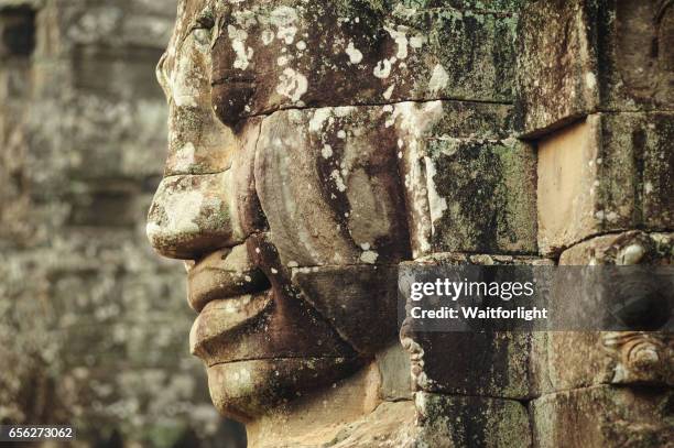 carving of a face at bayon temple - khmer stock pictures, royalty-free photos & images