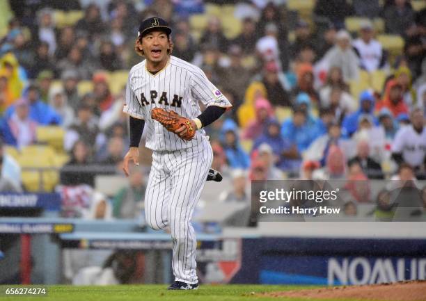 Nobuhiro Matsuda of team Japan reacts to his throw to first base in the third inning against team United States during Game 2 of the Championship...