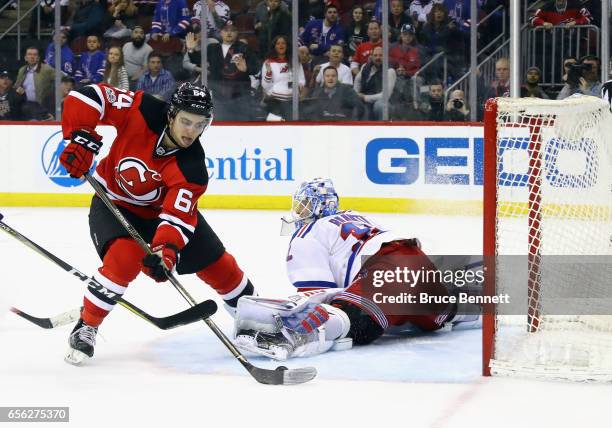 Joseph Blandisi of the New Jersey Devils scores at 4:05 of overtime against Antti Raanta of the New York Rangers at the Prudential Center on March...