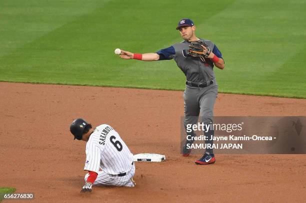 Ian Kinsler of team United States completes a double play as he throws Nobuhiro Matsuda of team Japan out at first and Hayato Sakamoto of team Japan...