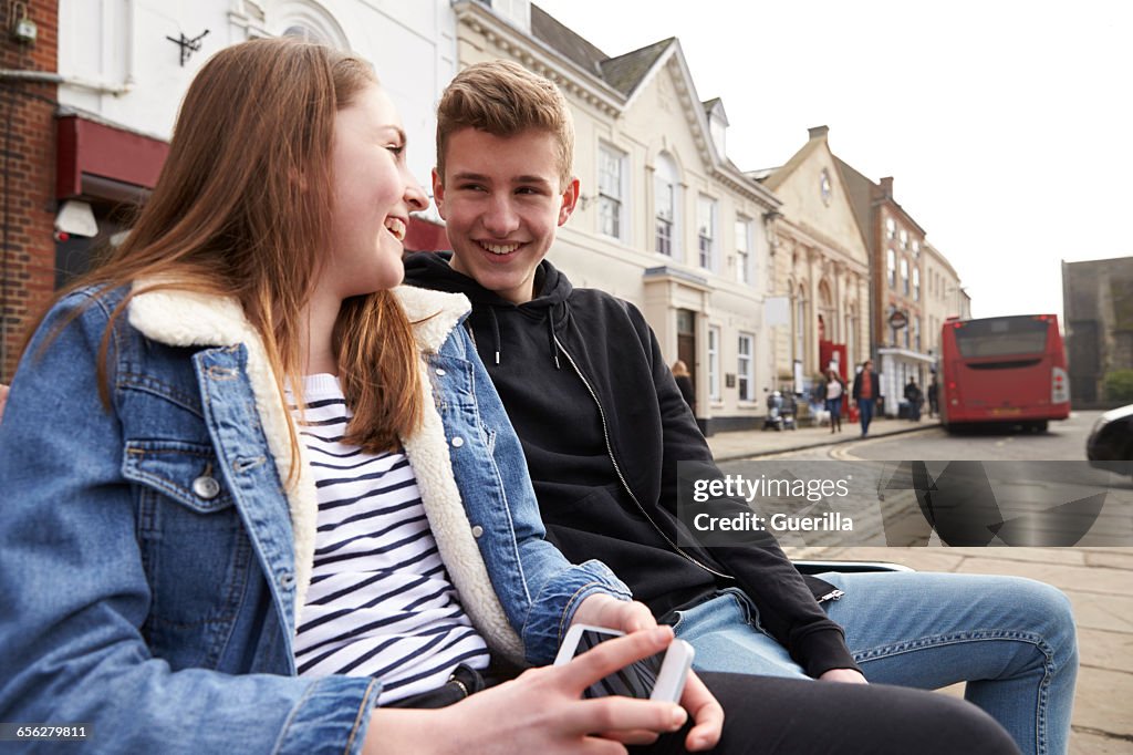 Teenage Couple Hanging Out Together In Urban Setting