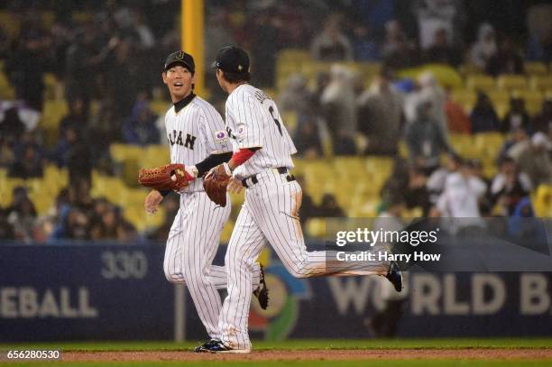 Shogo Akiyama celebrates the catch by Hayato Sakamoto of team Japan to end the fourth inning against the United States during Game 2 of the...